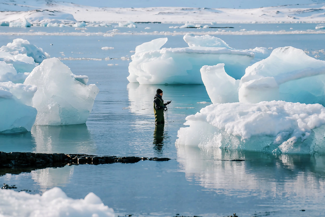 Elise Guillaume records the sounds of glacier ice melting in the Arctic using a hydrophone, Svalbard, 2023 © Tamara Šuša.